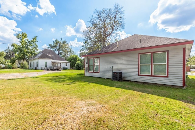 view of home's exterior featuring central AC unit and a lawn