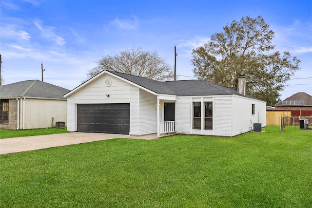 ranch-style home with a garage, a front yard, and cooling unit