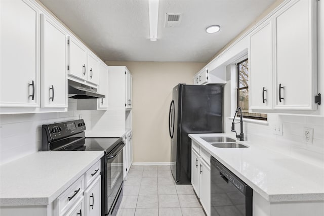 kitchen featuring tasteful backsplash, white cabinetry, sink, light tile patterned floors, and black appliances