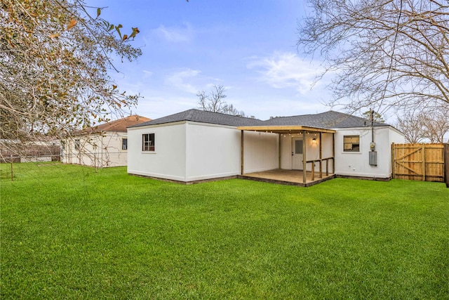 rear view of property with a yard and a patio