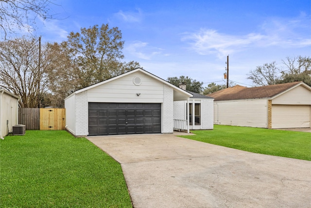 ranch-style home featuring a garage, central AC, an outbuilding, and a front yard