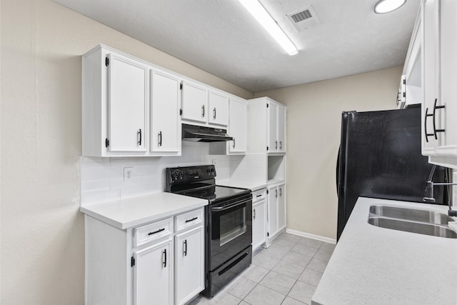 kitchen featuring light tile patterned floors, sink, black appliances, white cabinets, and decorative backsplash