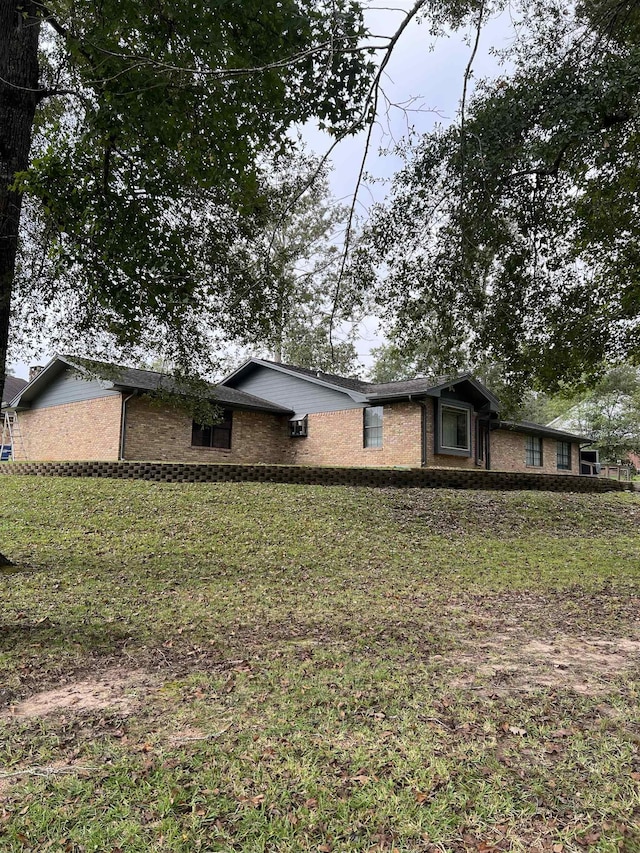 view of side of home featuring a lawn