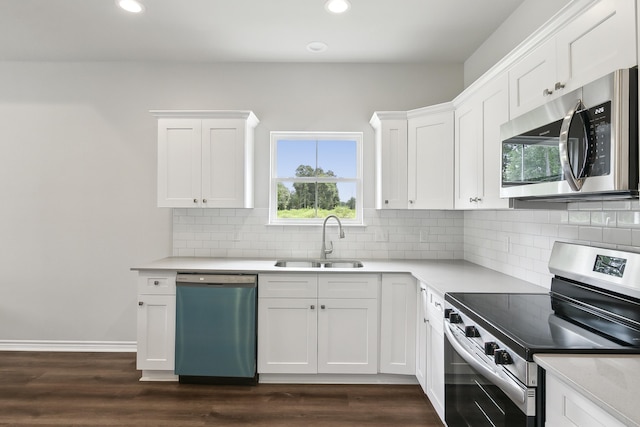 9896 Golden Ln, Lumberton, TX 77657 - kitchen featuring stainless steel appliances, light countertops, recessed lighting, dark wood-style flooring, and backsplash