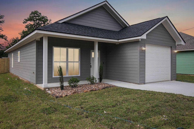 9896 Golden Ln, Lumberton, TX 77657 - ranch-style home with a shingled roof, an attached garage, concrete driveway, a yard, and covered porch