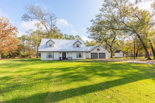 view of front of home featuring a front yard and a garage