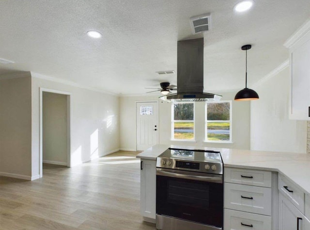 5260 Landry Ln, Beaumont, TX 77708 - kitchen featuring stainless steel electric range, island range hood, crown molding, light wood-type flooring, and white cabinetry
