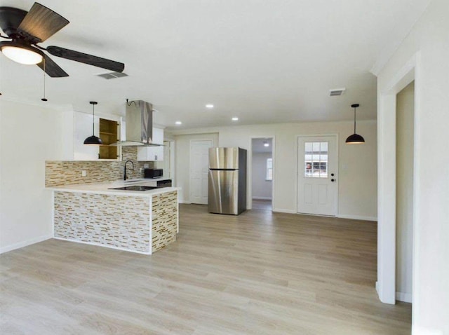 5260 Landry Ln, Beaumont, TX 77708 - kitchen featuring freestanding refrigerator, light countertops, decorative backsplash, light wood finished floors, and recessed lighting