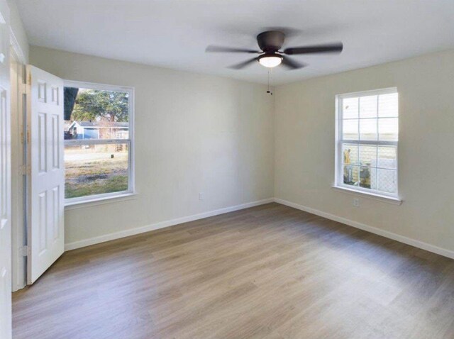 5260 Landry Ln, Beaumont, TX 77708 - unfurnished room featuring plenty of natural light, light wood-style floors, and ceiling fan