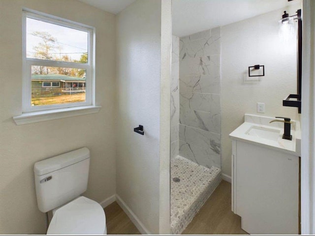 5260 Landry Ln, Beaumont, TX 77708 - bathroom featuring a marble finish shower, vanity, and wood finished floors