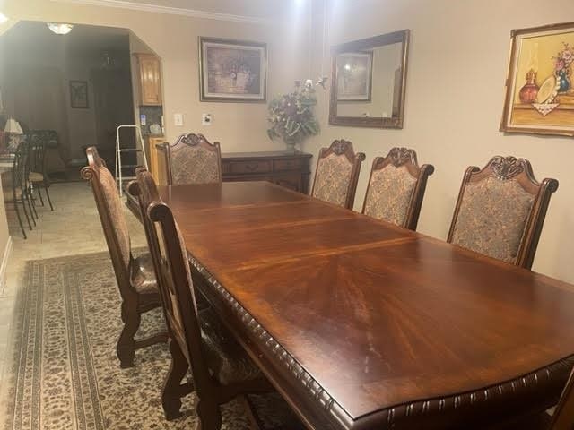 dining room featuring tile patterned floors and crown molding