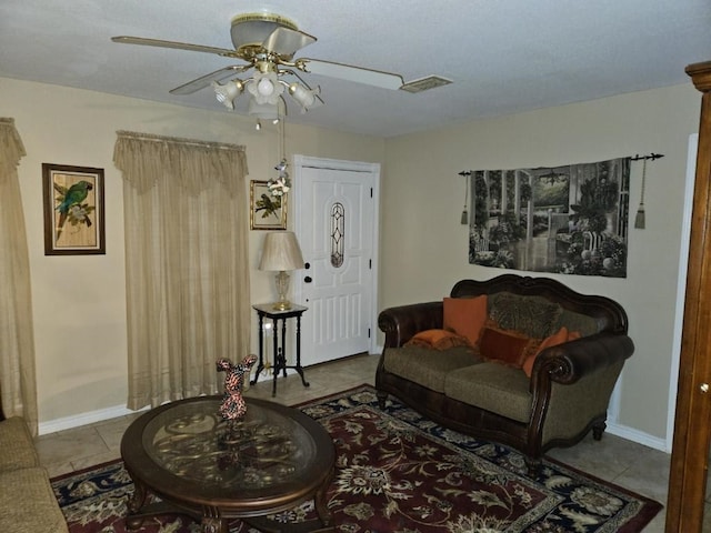 tiled living room with ceiling fan