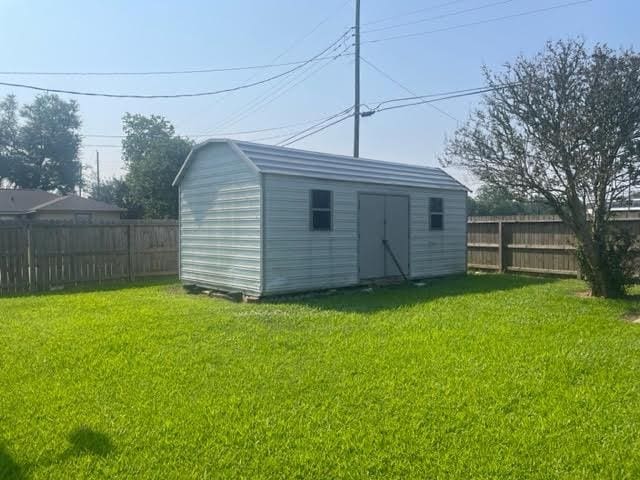 view of outdoor structure featuring a lawn