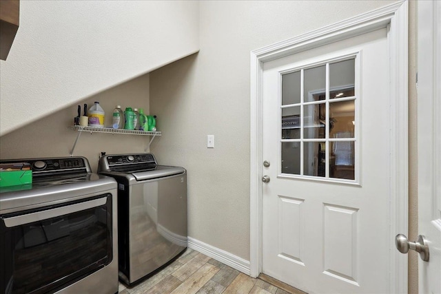2801 Magnolia Ln, Groves, TX 77619 - laundry room with separate washer and dryer, baseboards, and light wood-type flooring
