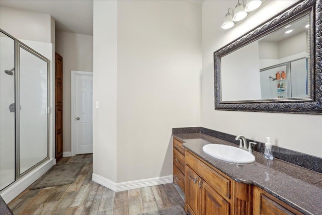 2801 Magnolia Ln, Groves, TX 77619 - full bath with a stall shower, wood finished floors, vanity, and baseboards