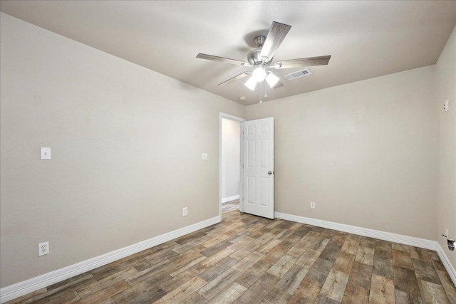 2801 Magnolia Ln, Groves, TX 77619 - empty room with a ceiling fan, baseboards, and wood finished floors