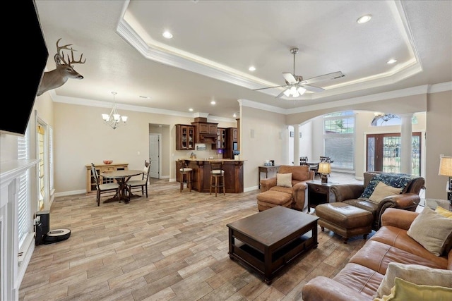 2801 Magnolia Ln, Groves, TX 77619 - living area featuring a tray ceiling, arched walkways, decorative columns, light wood finished floors, and crown molding