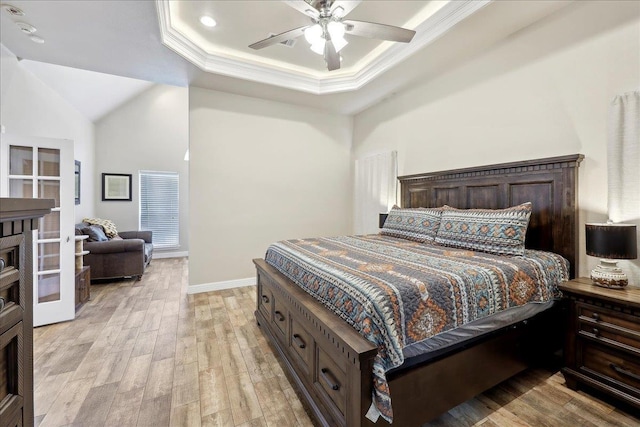 2801 Magnolia Ln, Groves, TX 77619 - bedroom featuring light wood-type flooring, ornamental molding, a tray ceiling, baseboards, and a ceiling fan