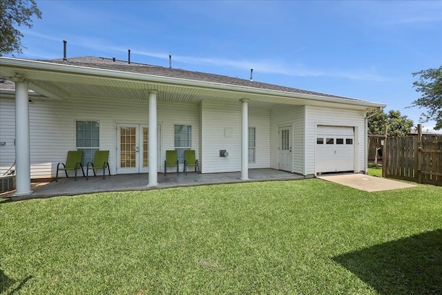 2801 Magnolia Ln, Groves, TX 77619 - rear view of house featuring french doors, an attached garage, and a patio