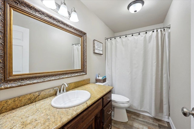 2801 Magnolia Ln, Groves, TX 77619 - bathroom with wood finished floors, vanity, and toilet