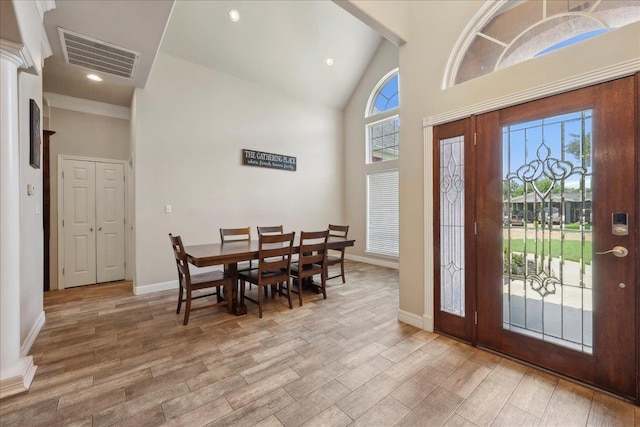 2801 Magnolia Ln, Groves, TX 77619 - foyer entrance with wood finished floors, high vaulted ceiling, baseboards, and recessed lighting