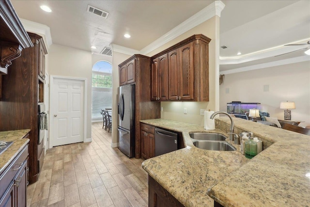 2801 Magnolia Ln, Groves, TX 77619 - kitchen with stainless steel appliances, a sink, ornamental molding, light stone countertops, and light wood-type flooring