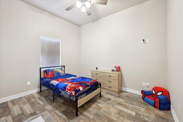 2801 Magnolia Ln, Groves, TX 77619 - bedroom with light wood finished floors, baseboards, and a ceiling fan