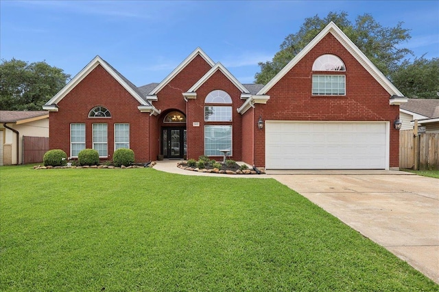 2801 Magnolia Ln, Groves, TX 77619 - traditional home with a garage, driveway, and brick siding