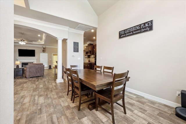 2801 Magnolia Ln, Groves, TX 77619 - dining space with ceiling fan, decorative columns, light wood-style floors, crown molding, and baseboards