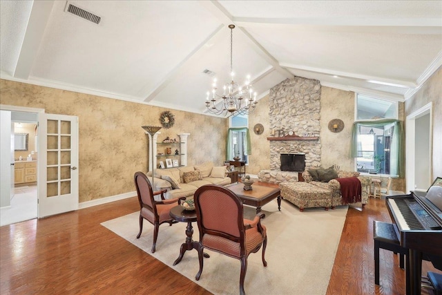 living area featuring visible vents, wood finished floors, vaulted ceiling with beams, a stone fireplace, and a chandelier