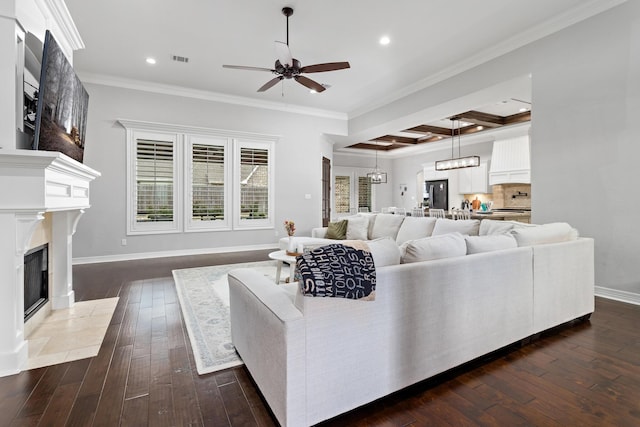 6526 Brayfield Ln, Beaumont, TX 77706 - living room with ceiling fan, recessed lighting, dark wood-style flooring, ornamental molding, and a fireplace