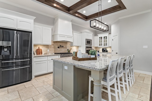 6526 Brayfield Ln, Beaumont, TX 77706 - kitchen with stainless steel appliances, custom exhaust hood, stone tile flooring, crown molding, and tasteful backsplash