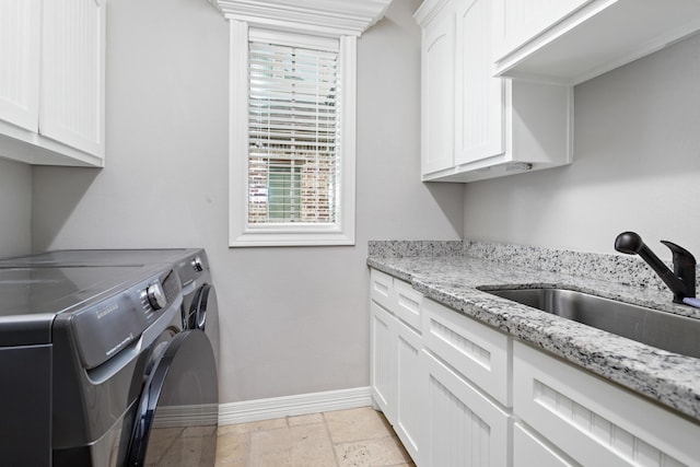 6526 Brayfield Ln, Beaumont, TX 77706 - washroom featuring washer and dryer, cabinet space, plenty of natural light, and stone tile flooring