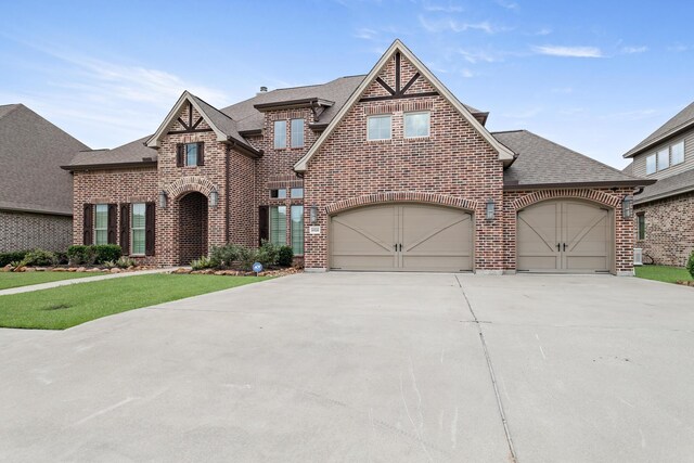 6526 Brayfield Ln, Beaumont, TX 77706 - view of front facade featuring brick siding, a shingled roof, driveway, a front yard, and an attached garage