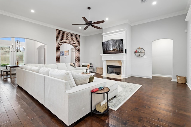 6526 Brayfield Ln, Beaumont, TX 77706 - living room featuring a ceiling fan, arched walkways, recessed lighting, dark wood finished floors, and a tiled fireplace