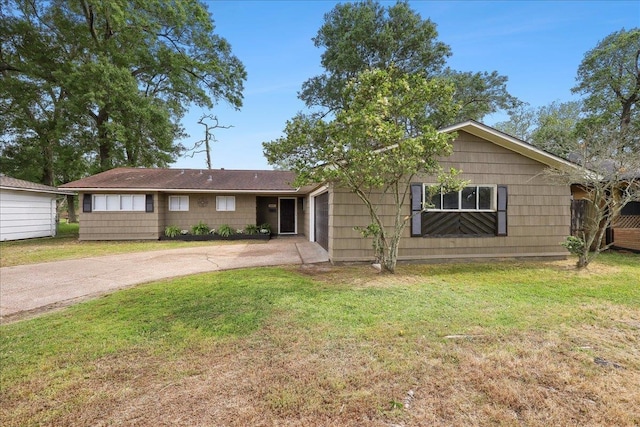 ranch-style home with driveway and a front lawn