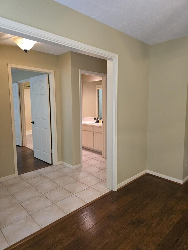 unfurnished room with light wood finished floors and baseboards