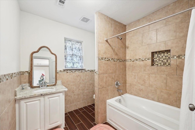 4592 Shakespeare Ln, Kountze, TX 77625 - bathroom featuring tile walls, shower / bath combo with shower curtain, vanity, and a wainscoted wall