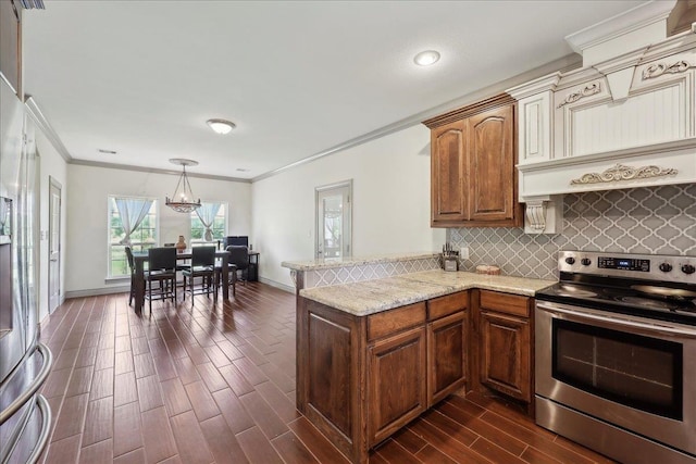 4592 Shakespeare Ln, Kountze, TX 77625 - kitchen featuring appliances with stainless steel finishes, ornamental molding, a chandelier, a peninsula, and dark wood finished floors