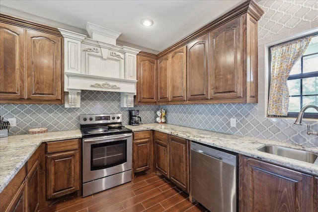 4592 Shakespeare Ln, Kountze, TX 77625 - kitchen with stainless steel appliances, dark wood-type flooring, light stone countertops, and tasteful backsplash