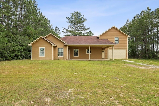 4592 Shakespeare Ln, Kountze, TX 77625 - view of front of home with a garage and a front yard