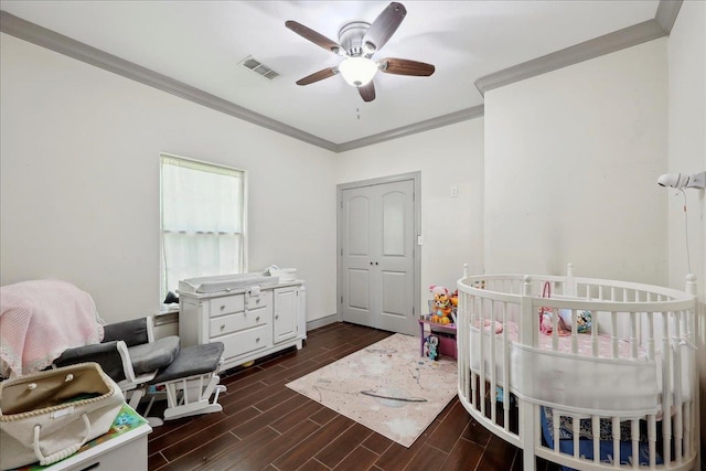 4592 Shakespeare Ln, Kountze, TX 77625 - bedroom featuring crown molding, dark wood-style flooring, a nursery area, and a ceiling fan