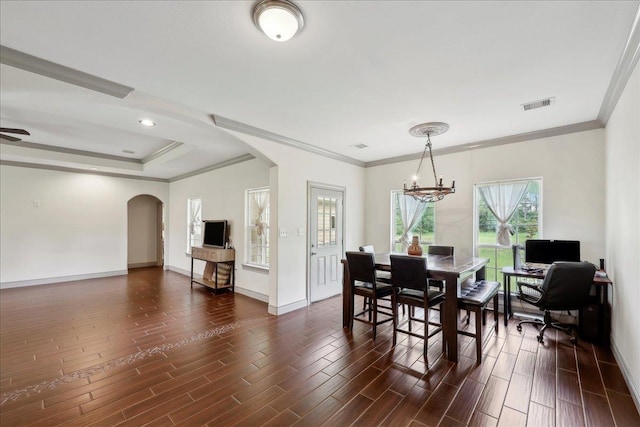 4592 Shakespeare Ln, Kountze, TX 77625 - dining area with arched walkways, crown molding, a chandelier, and dark wood-type flooring