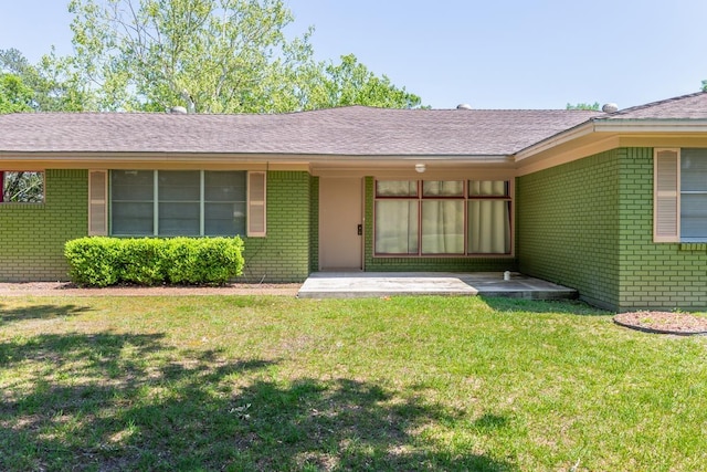 515 Watts Rd, Silsbee, TX 77656 - entrance to property with brick siding, a yard, and roof with shingles