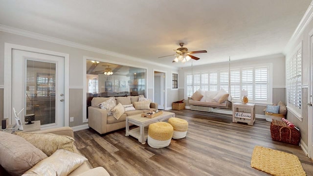 living room featuring crown molding, ceiling fan, and wood-type flooring