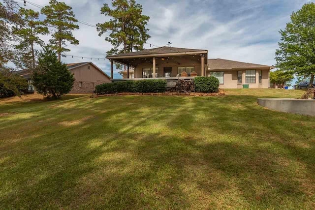 back of house with a lawn