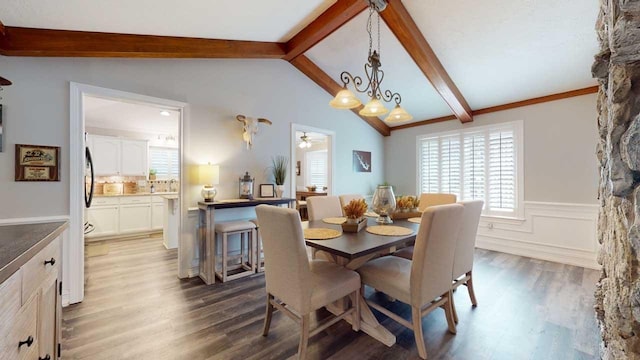 dining area featuring lofted ceiling with beams, dark hardwood / wood-style flooring, and ceiling fan with notable chandelier