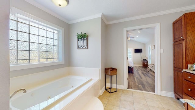 bathroom featuring a tub to relax in, tile patterned floors, and ornamental molding