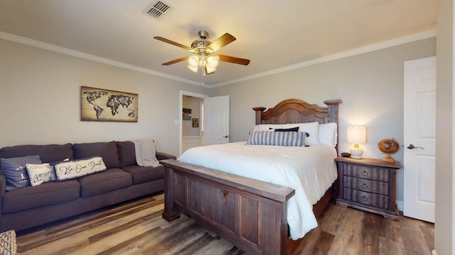 bedroom featuring dark hardwood / wood-style floors, ceiling fan, and crown molding