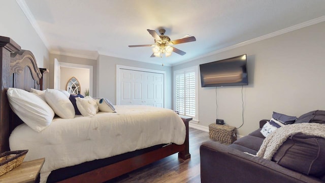 bedroom with ceiling fan, dark hardwood / wood-style flooring, ornamental molding, and a closet